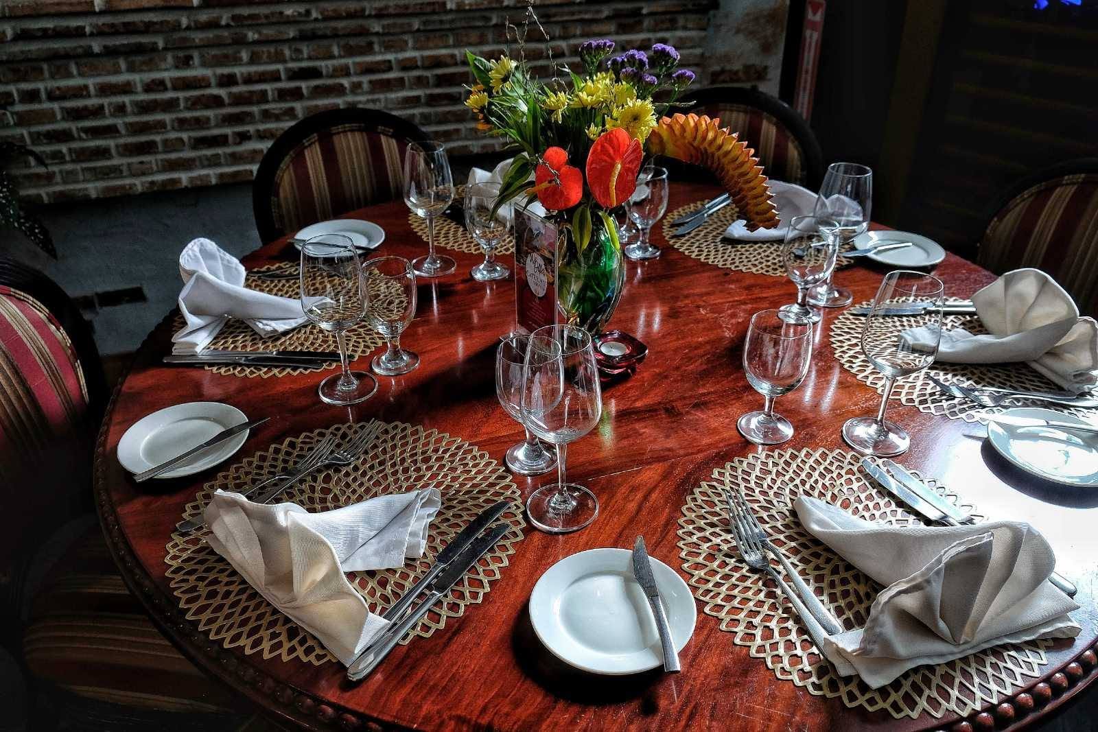 A warmly lit table setting inside L’Opera
